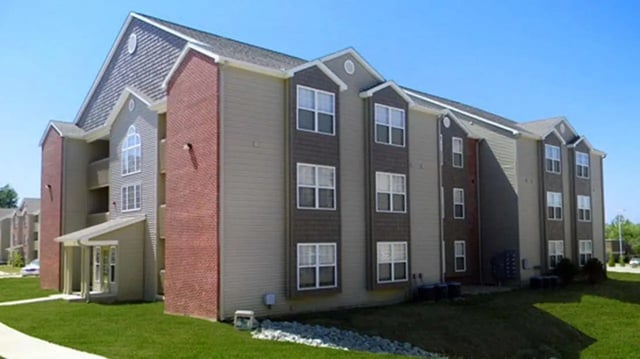 Exterior building with multiple windows and brick accents Exterior at 900 on Park Apartments in Carbondale Student Accommodation