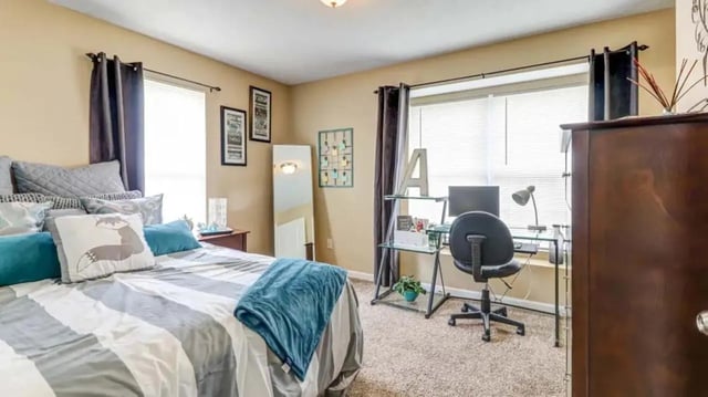 Bed with desk and computer bedroom at 900 on Park Apartments in Carbondale Student Accommodation