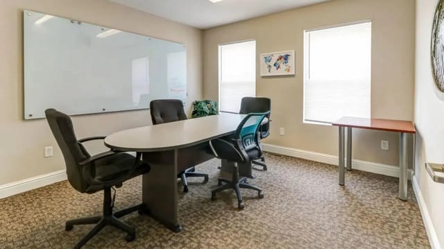 Oval table chairs whiteboard study area at 900 on Park Apartments in Carbondale Student Accommodation