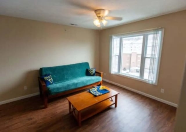 Teal futon wood table window living room at Metro Towers in Morgantown Student Accommodation