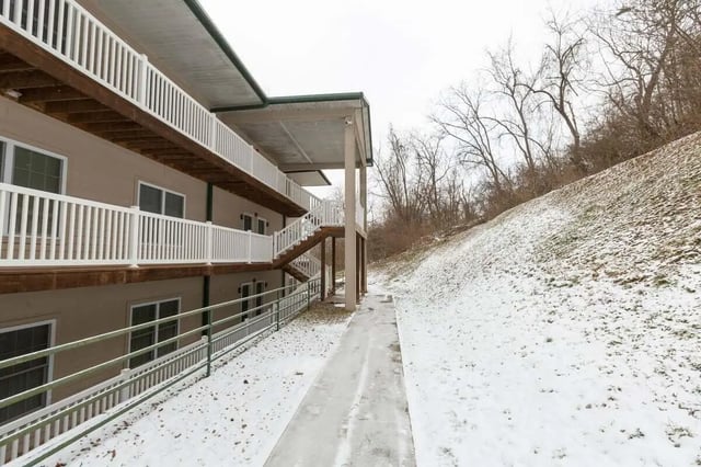 Exterior building with multiple balconies and snowy hillside exterior at Metro Towers in Morgantown Student Accommodation