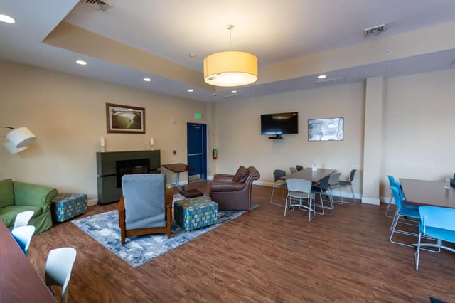 Sofa fireplace chairs tables living room at Central Place in Morgantown Student Accommodation