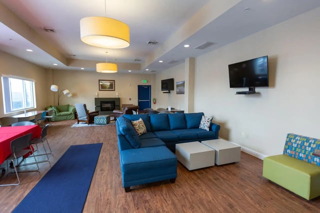 Blue sectional sofa with white coffee tables living room at Central Place in Morgantown Student Accommodation