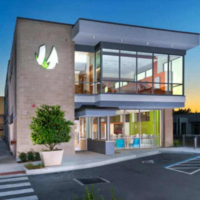 Modern building with large windows and tree exterior at Apartments Near UF in Gainesville Student Accommodation