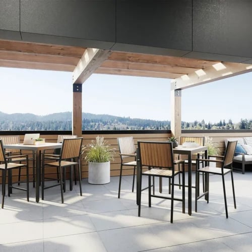 Outdoor patio with tables chairs and plants patio at Ferry Street Flats in Eugene Student Accommodation