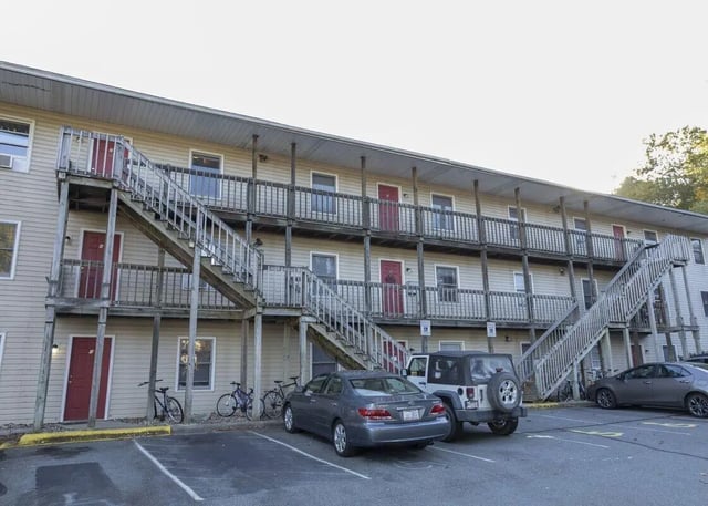 Apartment building with stairs cars bikes exterior at Boone High Country Rentals in Boone Student Accommodation