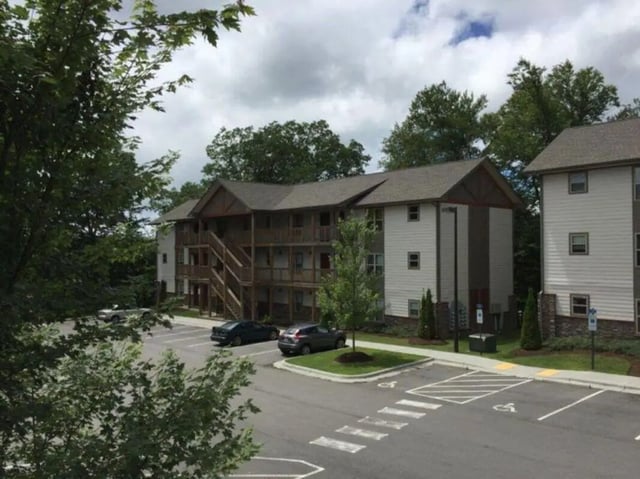 Apartment building with parking lot exterior at Boone High Country Rentals in Boone Student Accommodation