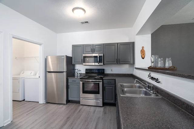 Stainless steel refrigerator stove microwave gray cabinets kitchen at Station 21 in West Lafayette Student Accommodation