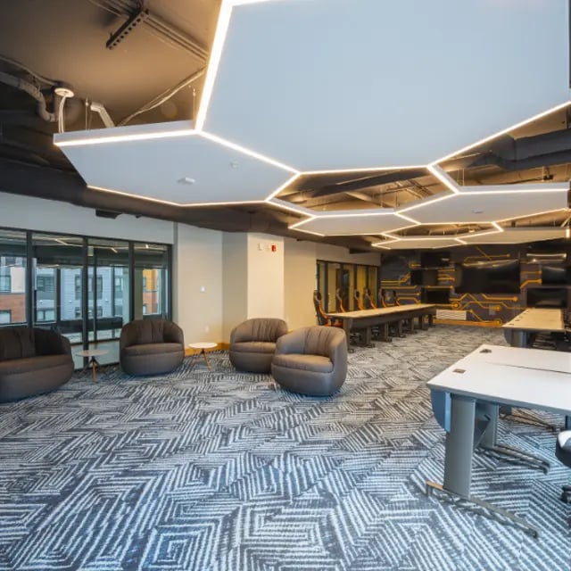 Four armchairs, conference tables, desk tables common area at Apex Apartments in Rochester Student Accommodation