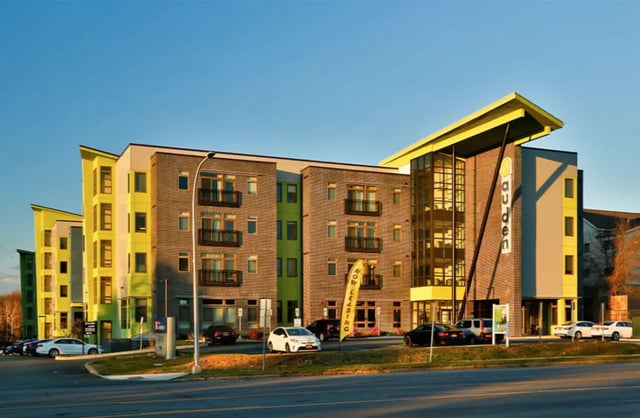 Modern apartment building with balconies and yellow exterior exterior at Auden Albany in Albany Student Accommodation