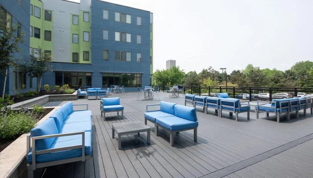 Blue sofas tables and chairs on deck area at Auden Albany in Albany Student Accommodation