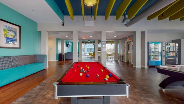 Pool table vending machines couch artwork amenity area at Auden Albany in Albany Student Accommodation