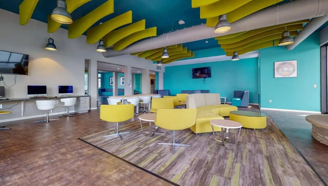 Computers lounge chairs and tables common area at Auden Albany in Albany Student Accommodation