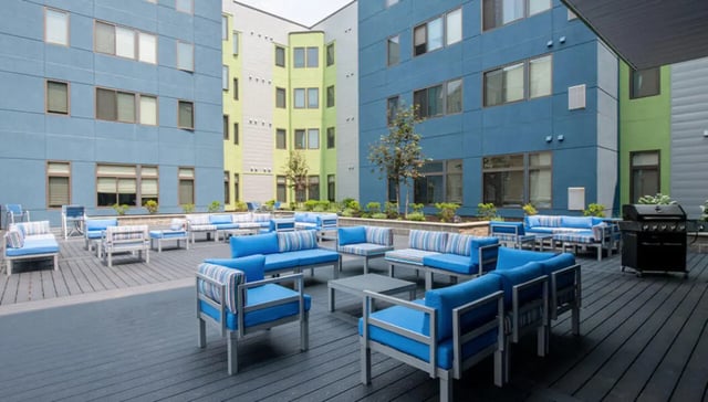 Blue sofas and tables outdoor amenity area at Auden Albany in Albany Student Accommodation