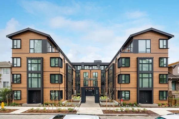 Modern apartment building entrance with balconies and windows exterior at Juno Studios in Seattle Student Accommodation