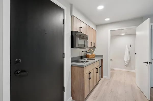 Modern kitchenette with microwave sink and cabinets kitchen at Juno Studios in Seattle Student Accommodation