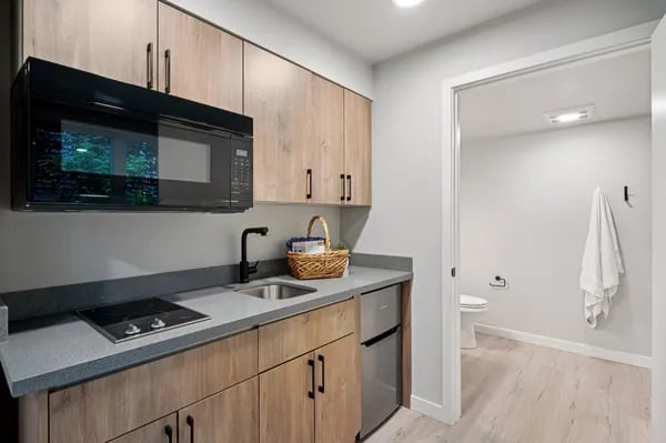 Kitchen with microwave sink and toilet bathroom at Juno Studios in Seattle Student Accommodation