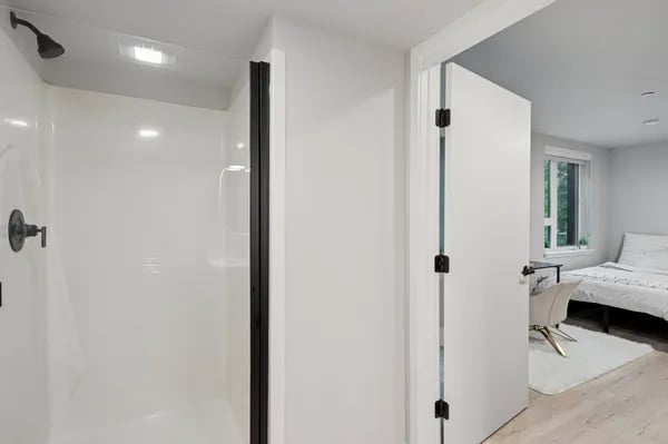 Shower stall and bedroom beyond bathroom at Juno Studios in Seattle Student Accommodation