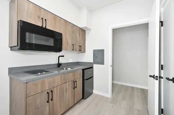 Microwave sink mini fridge cabinetry kitchen at Juno Studios in Seattle Student Accommodation