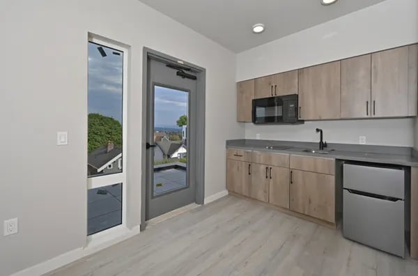 Modern kitchen with cabinets microwave sink mini fridge Kitchen at Juno Studios in Seattle Student Accommodation