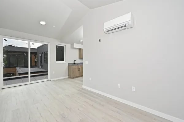 Sliding glass door window AC unit and cabinets living room at Juno Studios in Seattle Student Accommodation