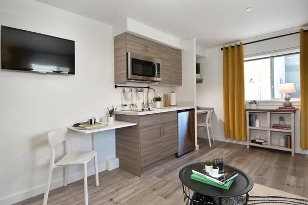 Kitchenette with dining table and living area Living room at Juno Studios in Seattle Student Accommodation