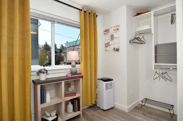 Bookshelf lamp window air conditioner closet Bedroom at Juno Studios in Seattle Student Accommodation