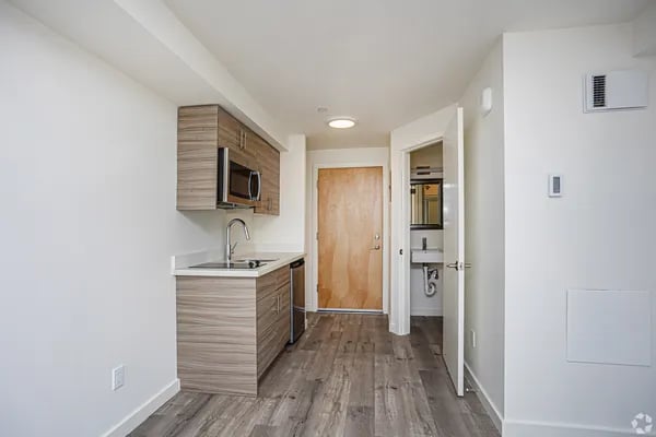Cabinets microwave sink and door kitchen and bathroom at Juno Studios in Seattle Student Accommodation