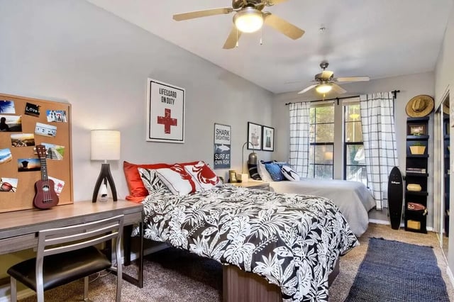 Two beds desk ukulele and surfboards bedroom at Fifty Twenty-Five Apartments in San Diego Student Accommodation