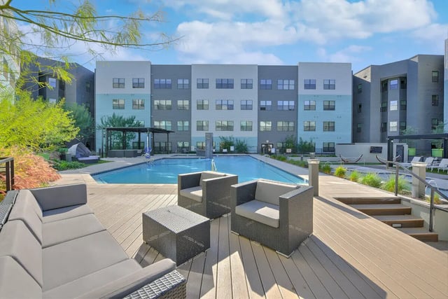 Outdoor seating lounge chairs pool and building exterior at Park Place Tempe in Tempe Student Accommodation