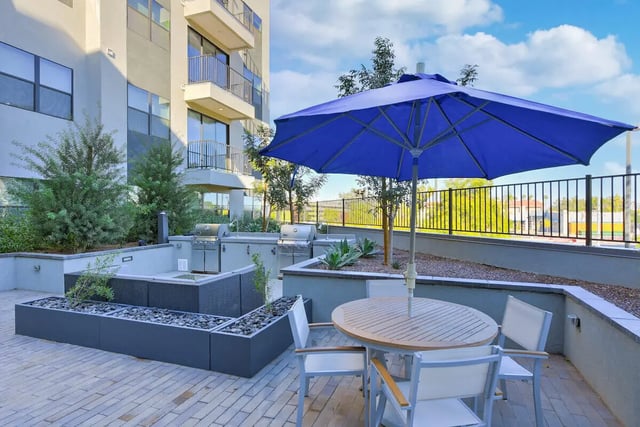 Outdoor seating area with grills and table. Exterior. at Park Place Tempe in Tempe Student Accommodation