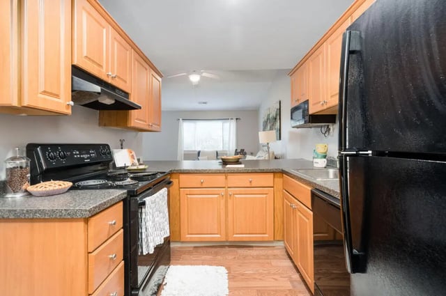 Light wood cabinets black appliances pie kitchen at Arbor Glen Apartments in East Lansing Student Accommodation