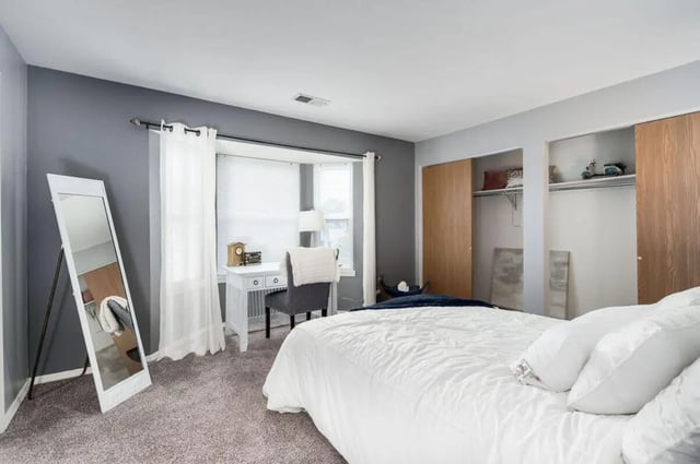 Bed mirror desk chair closets bedroom at Arbor Glen Apartments in East Lansing Student Accommodation