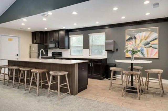 Bar stools and island in a kitchen area at Arbor Glen Apartments in East Lansing Student Accommodation