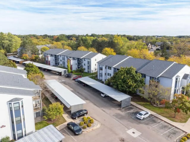 Apartment buildings with covered parking exterior at Arbor Glen Apartments in East Lansing Student Accommodation
