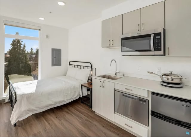 Bed sink microwave dishwasher refrigerator studio apartment at Fifty Two Apartments in Seattle Student Accommodation