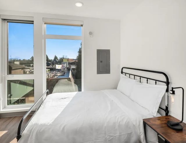 Bed with white linens and bedside table bedroom at Fifty Two Apartments in Seattle Student Accommodation