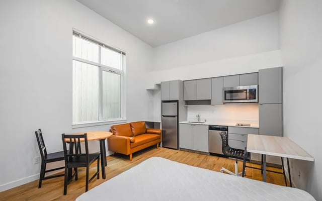 Sofa dining table kitchen area studio apartment at Fifty Two Apartments in Seattle Student Accommodation