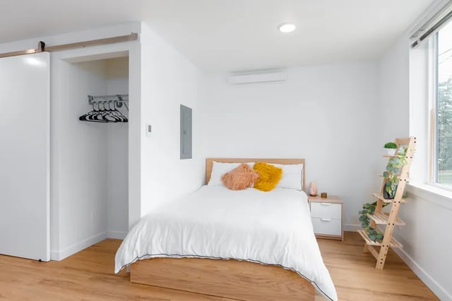 Bed with pillows closet and shelf bedroom at Fifty Two Apartments in Seattle Student Accommodation