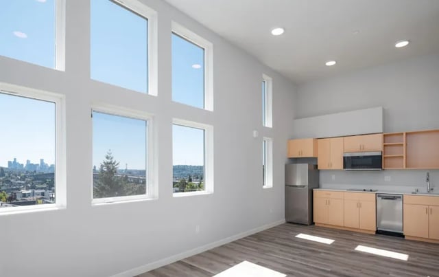 Large windows, modern kitchen, stainless steel appliances, studio apartment at Fifty Two Apartments in Seattle Student Accommodation