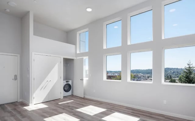 Washer and closet with large windows loft area living room at Fifty Two Apartments in Seattle Student Accommodation