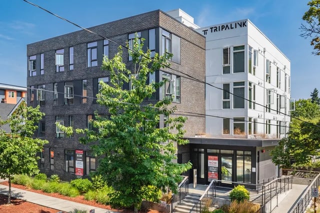 Modern apartment building entrance with trees exterior at Fifty Two Apartments in Seattle Student Accommodation