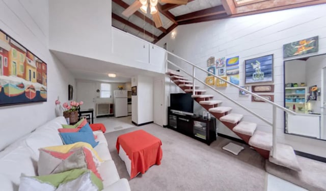 Living room with sofa stairs and TV living room at Arbor Lofts in Gainesville Student Accommodation
