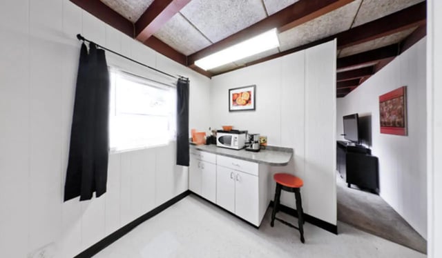 Kitchenette with microwave coffee maker and stool kitchen at Arbor Lofts in Gainesville Student Accommodation