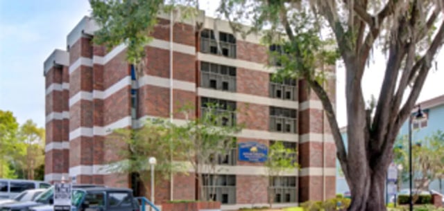 Brick building with white stripes exterior at Arbor Lofts in Gainesville Student Accommodation