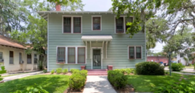 Light green house with red trim exterior exterior at Arbor Lofts in Gainesville Student Accommodation