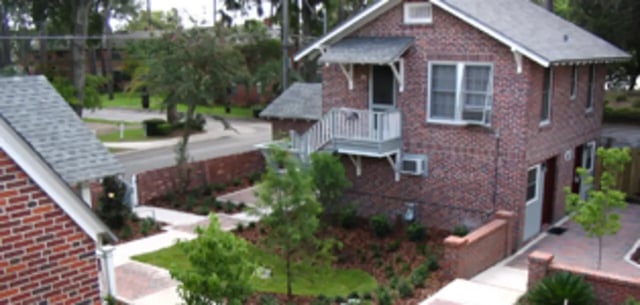 Brick building with balcony and landscaping exterior at Arbor Lofts in Gainesville Student Accommodation
