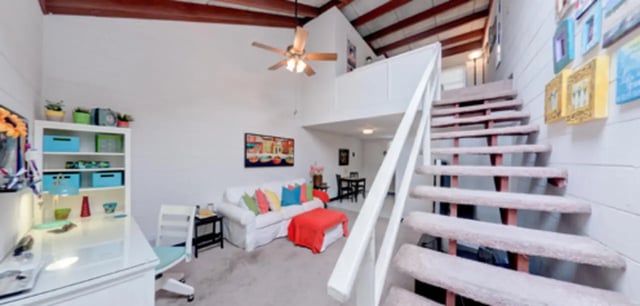 White sofa colorful pillows orange ottoman living area interior at Arbor Lofts in Gainesville Student Accommodation