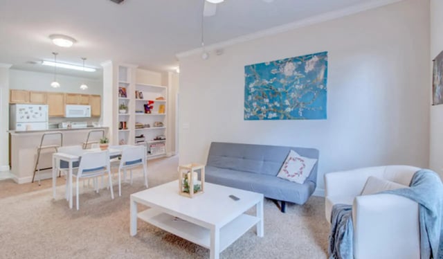 White table blue sofa white armchair living room at Heritage Oaks Luxury Apartments in Gainesville Student Accommodation