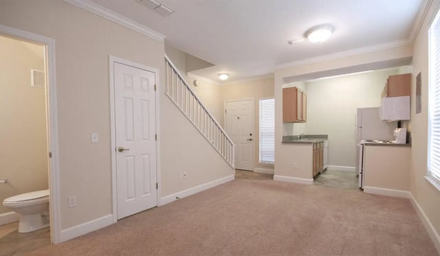 Toilet stairs and kitchen area living room at Heritage Oaks Luxury Apartments in Gainesville Student Accommodation